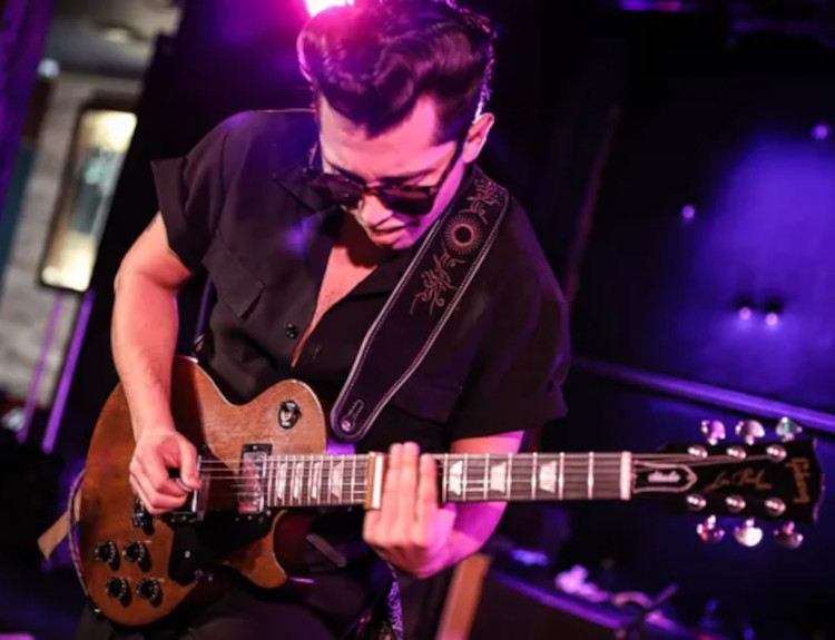 Andrew Alvarez performing on stage