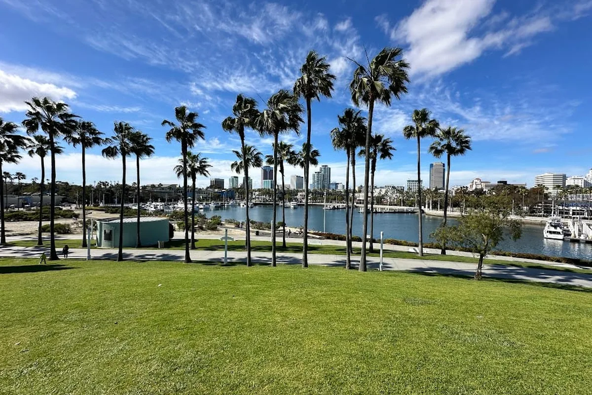 Shoreline Aquatic Park waterfront with festival setup, ocean views, and green spaces in Long Beach, CA